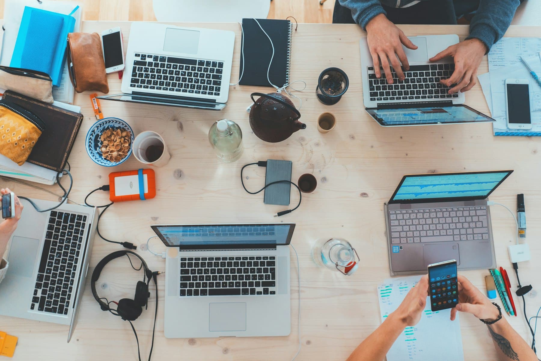 Équipe travaillant sur ordinateurs portables autour d’une table